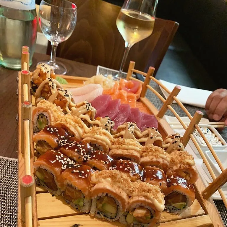 Sushi-Boot mit Wein am gedeckten Tisch